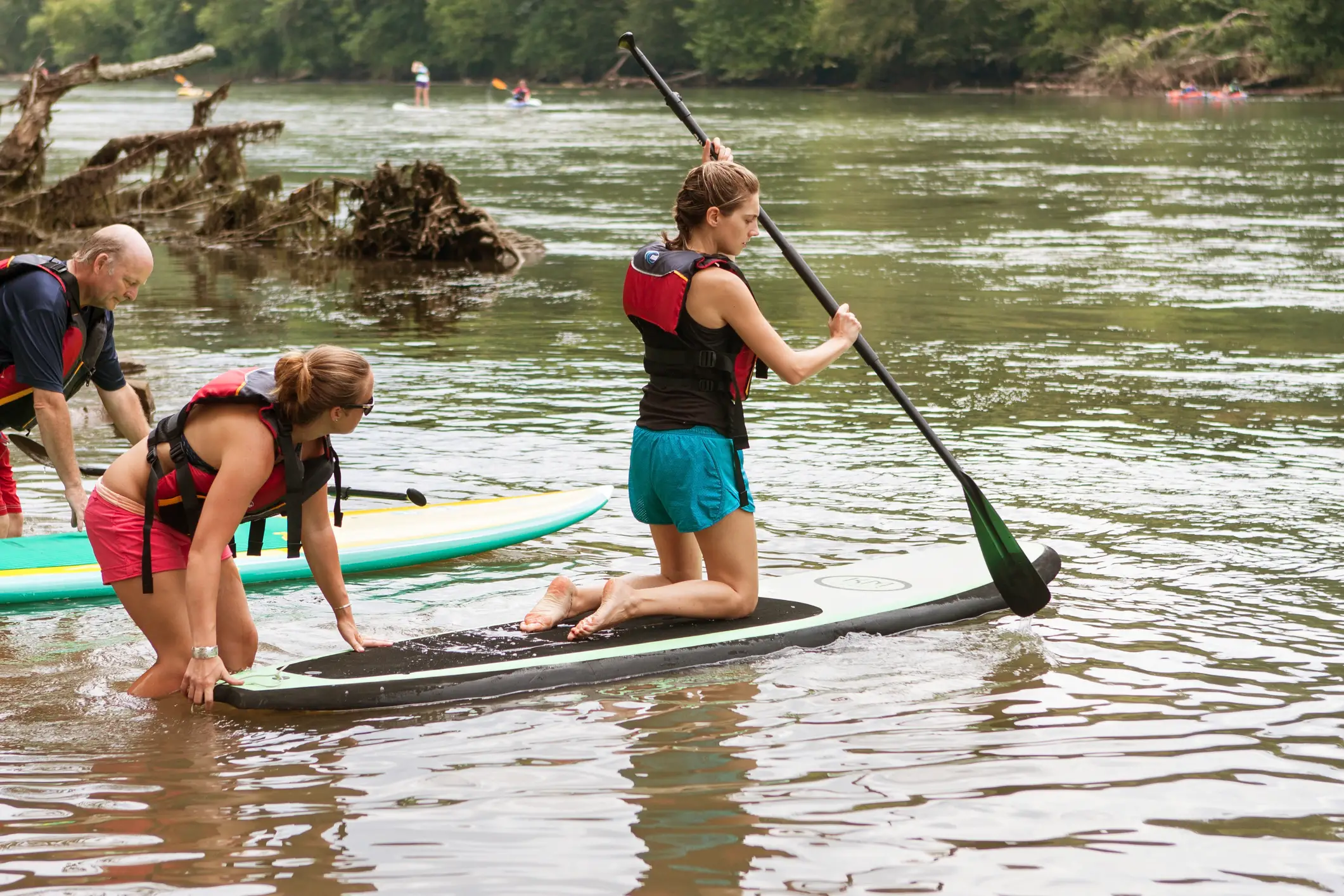 Woman Paddle Boarding in River