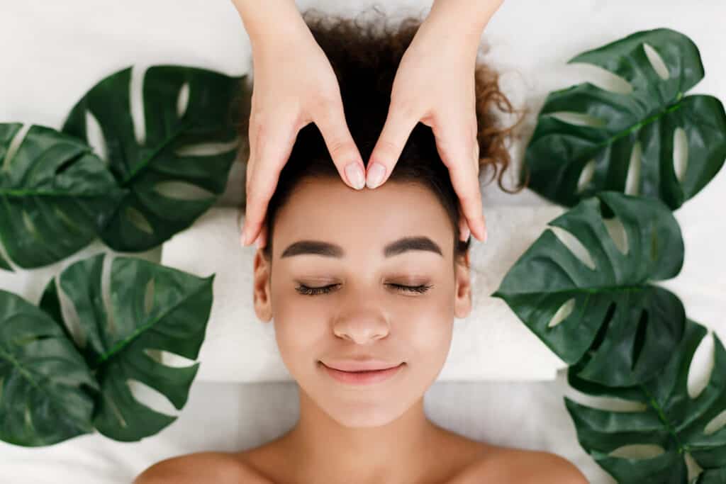 woman getting a head massage at spa