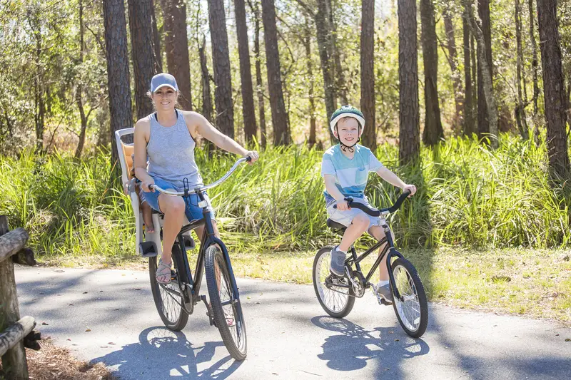 Mom and kids biking on bike trail