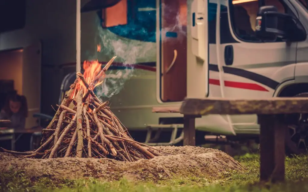 RV Camper with a campfire burning