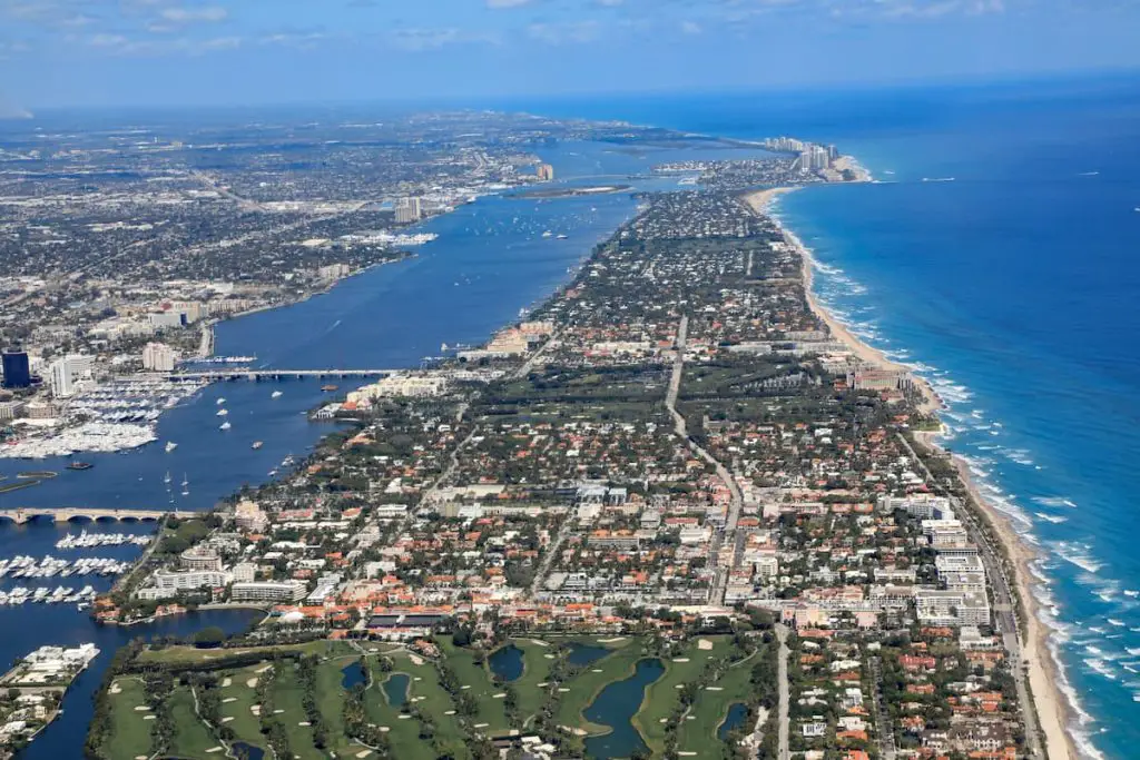 Aerial view of beautiful Palm Beach and Singer Island, Florida, along with the Atlantic Ocean, and the red roof tops of Worth Avenue. 